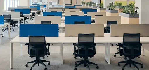 Modern open-plan office space featuring clean workstations, ergonomic chairs, and sanitized carpets provided by professional office cleaning services in Columbus, GA.