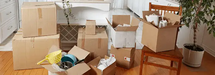 Packed moving boxes and household items in a kitchen before move-out or move-in cleaning, Columbus, GA.
